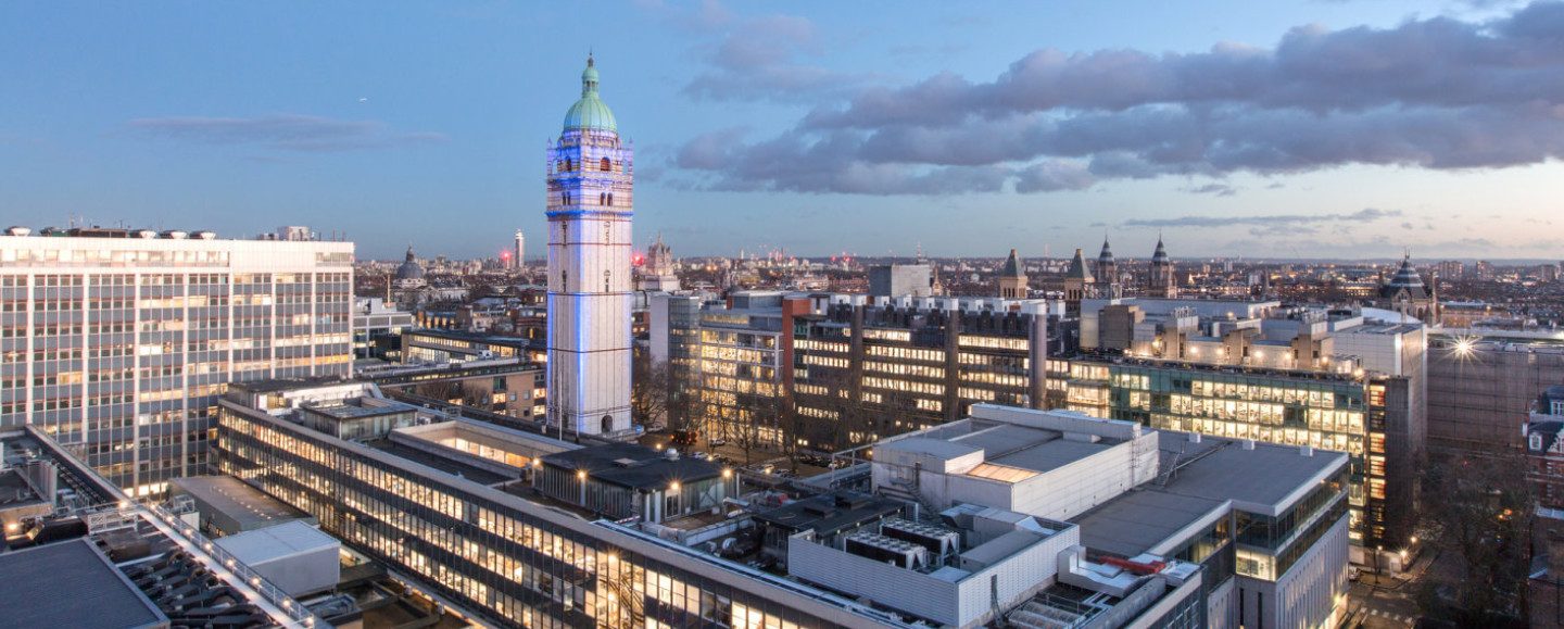 Imperial College London's South Kensington campus at dusk, the Queen's Tower lit above the lit-up buildings